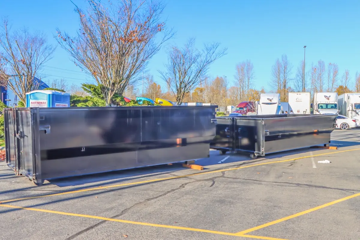 Professional dumpster rental service with roll-off container on residential driveway in Gleneagle